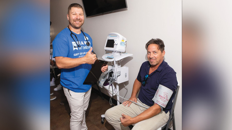 Baptist Hospitals of Southeast Texas volunteer Aaron Lockard, RN with a gift of Life client