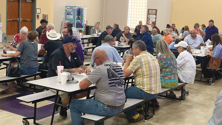 Attendees fill out surveys towards the end of the community meeting.