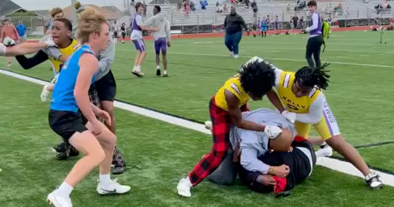 An image from a video shows players and adults engaged in a brawl.