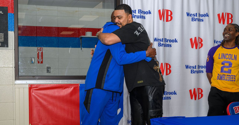 Andre Boutte shares an emotional moment with one of his former Lincoln players, Dominic Hardy.
