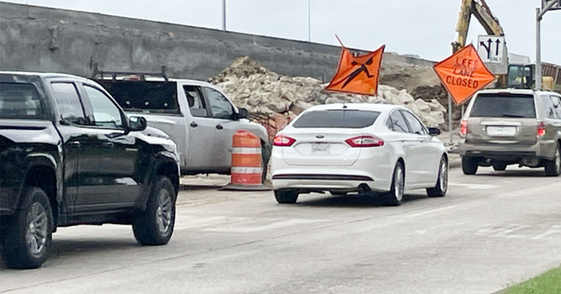Vehicles navigate through detours along the feeder road near Washington Boulevard.