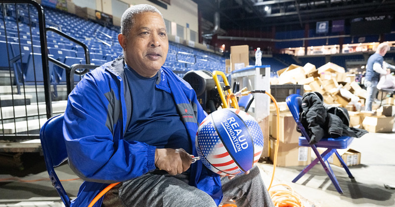 Over 1,000 basketballs are blown up by volunteers for distribution.