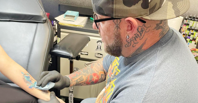 Moose Morrow finishes a tattoo on a recent customer.
