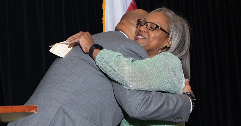 2024 honoree Delcie Thomas shares a heartfelt moment with Pastor John Adolph during the Reaud Excellence in Education Awards gala.