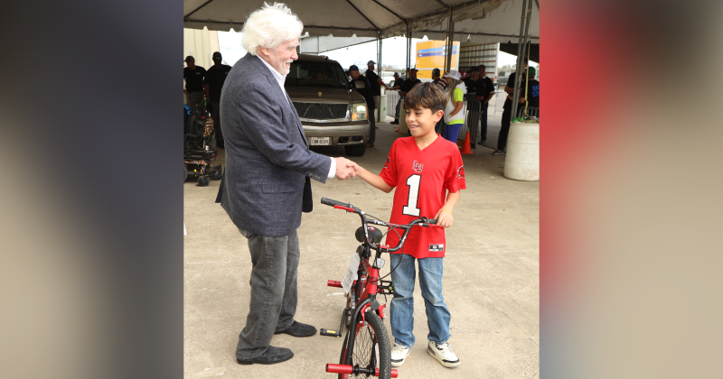 Wayne A. Reaud with young YMBL volunteer